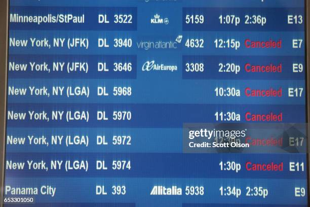 Departure board at O'Hare International Airport shows all flights to New York City canceled on March 14, 2017 in Chicago, Illinois. A snowstorm is...