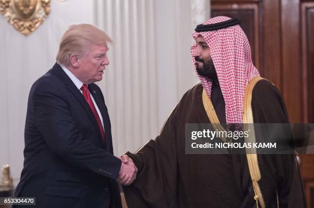 President Donald Trump and Saudi Deputy Crown Prince and Defense Minister Mohammed bin Salman shake hands in the State Dining Room before lunch at...