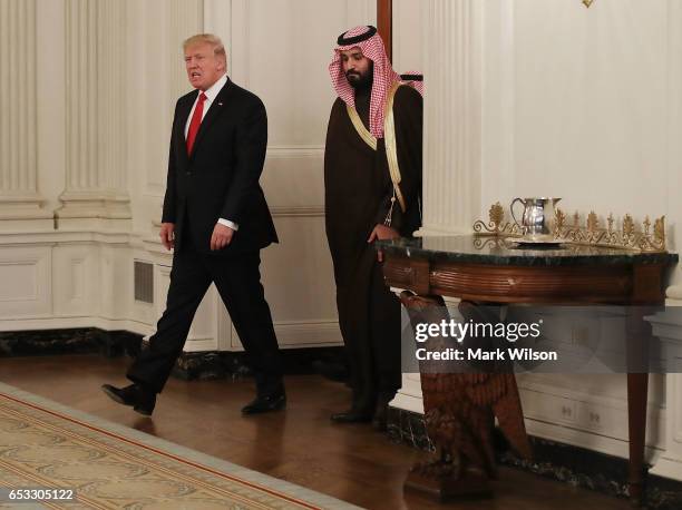 President Donald Trump walks into the State Dinning Room to have lunch with Mohammed bin Salman, Deputy Crown Prince and Minister of Defense of the...