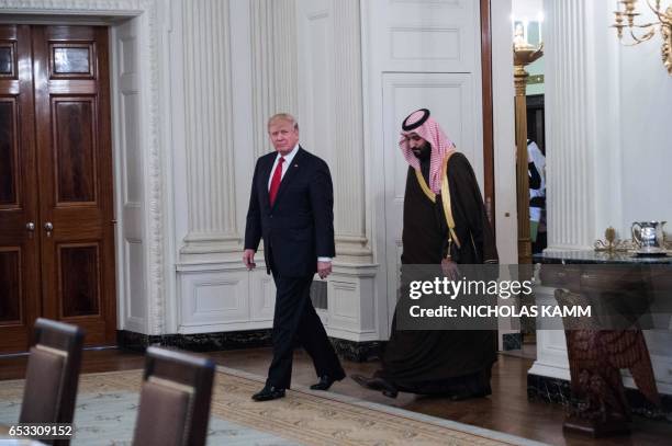 President Donald Trump and Saudi Deputy Crown Prince and Defense Minister Mohammed bin Salman enter the State Dining Room before lunch at the White...