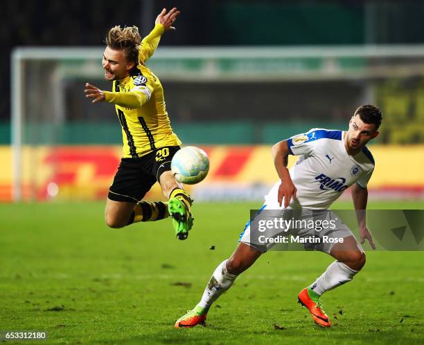 Marcel Schmelzer of Borussia Dortmund is challenged by Bernd Rosinger of VfL Sportfreunde Lotte during the DFB Cup quarter final between Sportfreunde...