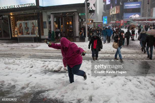 Tourists negotiate the snow in Times Square during a day of heavy snow and freezing rain on March 14, 2017 in New York City. Many Broadway...
