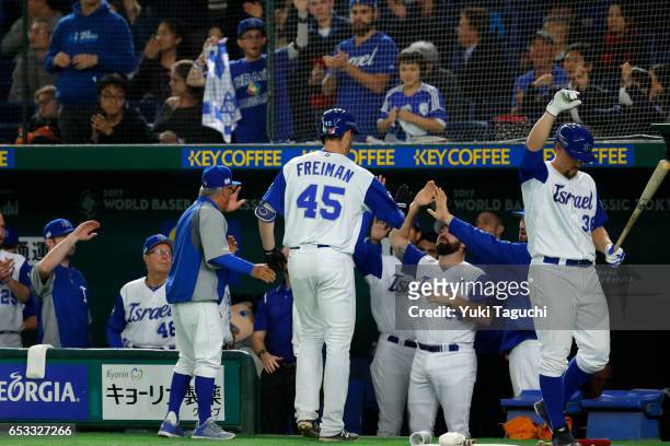 Nate Freiman of Team Israel is greeted in the dugout after hitting a home run in the fourth inning during Game 3 of Pool E of the 2017 World Baseball...