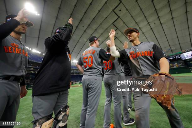 Andrelton Simmons of Team Netherlands celebrates with teammates after Team Netherlands defeated Team Israel in Game 3 of Pool E of the 2017 World...