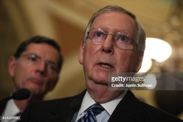 Senate Majority Leader Mitch McConnell speaks as Sen. John Barrasso looks on during a news conference on Capitol Hill on March 14, 2017 in...