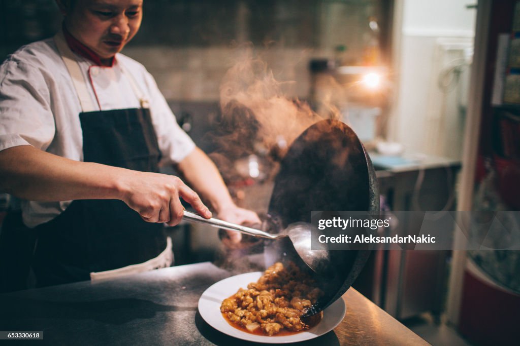 Chef preparing food in Chinese restaurant