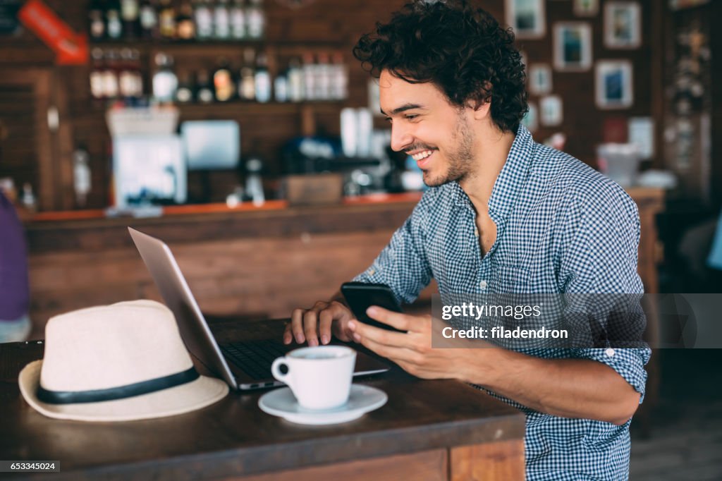 Attractive man surfing the net at the cafe