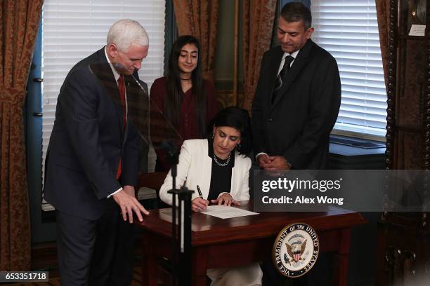 Seema Verma signs the affidavit of appointment during a swearing-in ceremony, officiated by U.S. Vice President Mike Pence , as her husband Sanjay...