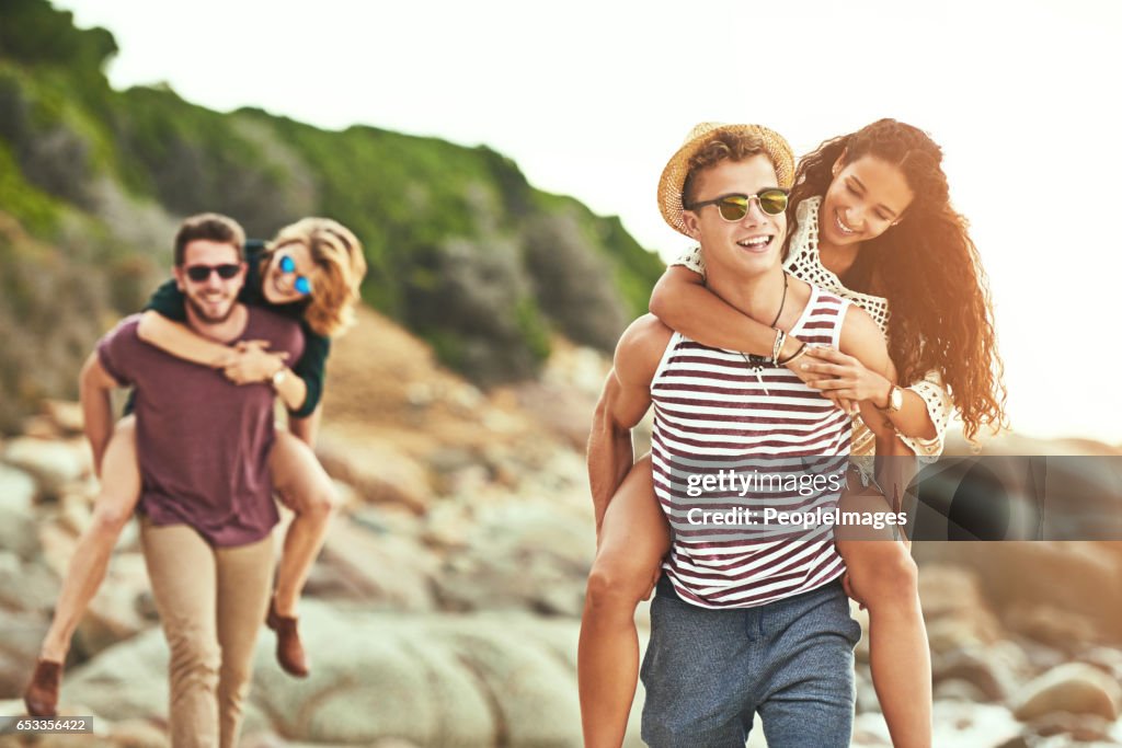 Piggybacking their girls on the beach