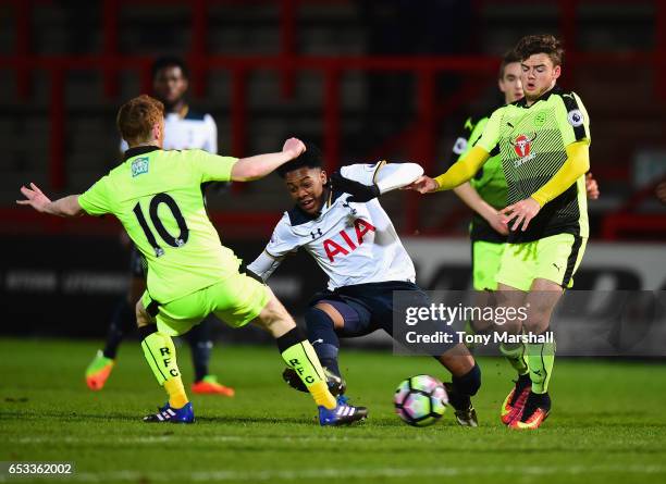 Jaden Brown of Tottenham Hotspur is tackled by Stephen Quinn and Tyler Frost of Reading during the Premier League 2 match between Tottenham Hotspur...