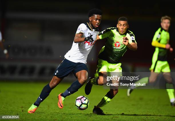 Josh Onomah of Tottenham Hotspur battles for the ball with Andy Rinomhota of Reading during the Premier League 2 match between Tottenham Hotspur and...