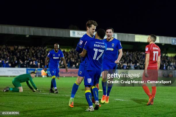 Wimbledon's Jake Reeves celebrates scoring the opening goal with team mate Andy Barcham during the Sky Bet League One match between A.F.C. Wimbledon...
