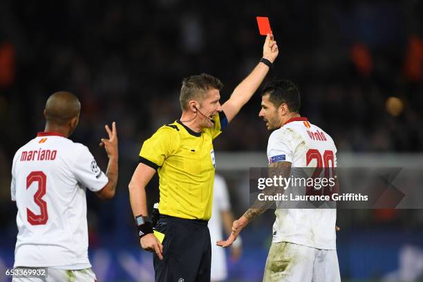 Vitolo of Sevilla remonstrates with referee Daniele Orsato of Italy as he shows the red card to Samir Nasri of Sevilla during the UEFA Champions...