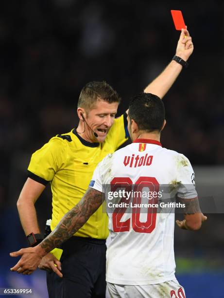 Vitolo of Sevilla remonstrates with referee Daniele Orsato of Italy as he shows the red card to Samir Nasri of Sevilla during the UEFA Champions...