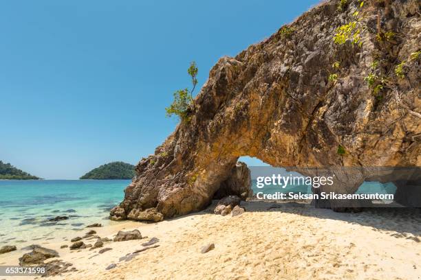 natural stone arch on beach at koh khai island, stun, thailand - ko lipe stock pictures, royalty-free photos & images