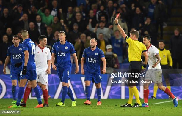 Referee Daniele Orsato of Italy shows the red card to Samir Nasri of Sevilla during the UEFA Champions League Round of 16, second leg match between...