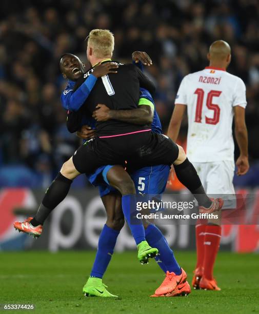 Wilfred Ndidi, Kasper Schmeichel and Wes Morgan of Leicester City celebrate as the final whistle blows during the UEFA Champions League Round of 16,...