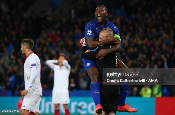 Wes Morgan of Leicester City celebrates with Leicester City goalkeeper Kasper Schmeichel after he saves a penalty during the UEFA Champions League...
