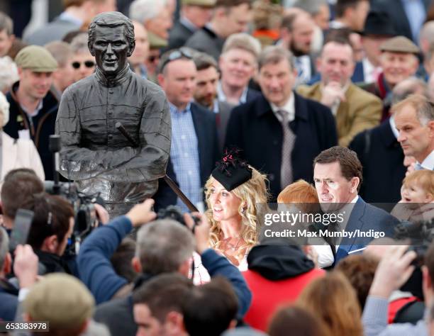 Sir AP McCoy accompanied by his wife Chanelle McCoy unveils a statue of himself on day 1 of the Cheltenham Festival at Cheltenham Racecourse on March...