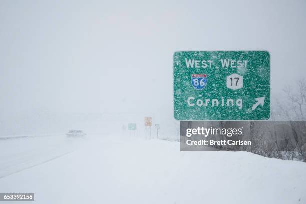 Motorist passes a sign for the route 86 on ramp outside of Binghamton, New York as snow continues to fall on March 14, 2017 in Vestal, New York. A...
