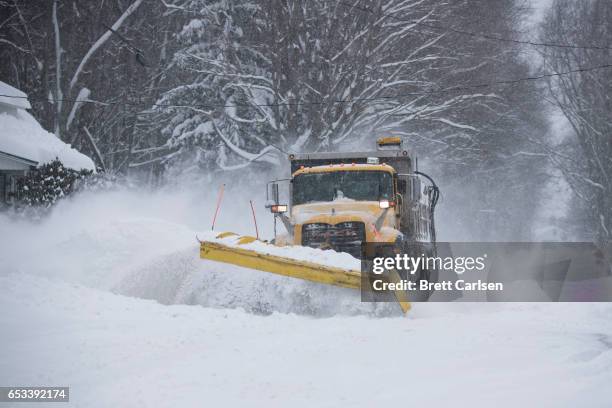 PennDOT plow trucks work to clear roads in northeastern Pennsylvania following snow fall up to two feet on March 14, 2017 in Scranton City. A...