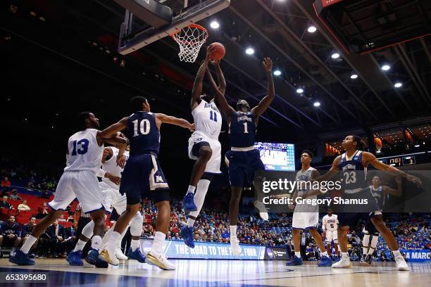 Michael Zeno of the New Orleans Privateers drives to the basket against Mawdo Sallah of the Mount St. Mary's Mountaineers during the first half of...