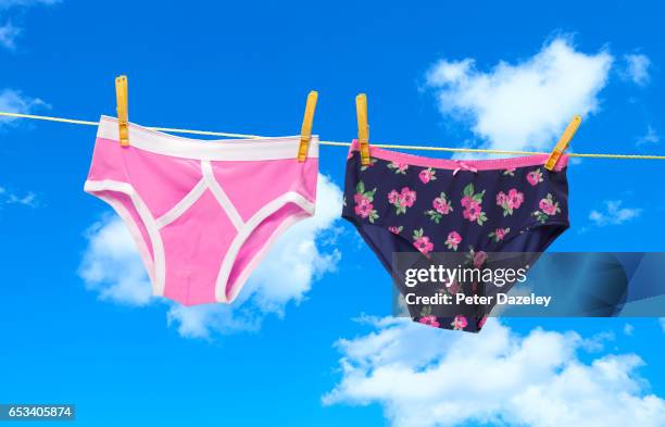 his and hers pants on the washing line - tanga imagens e fotografias de stock