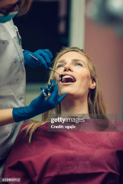 mid adult woman at dentist office. - anaesthetic stock pictures, royalty-free photos & images