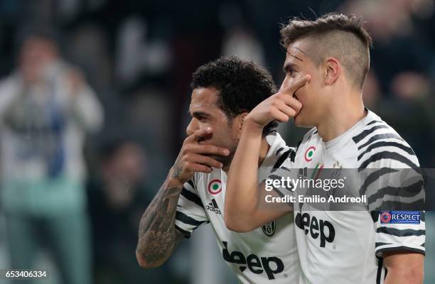 Paulo Dybala of Juventus FC celebrates with his team-mate Daniel Alves da Silva after scoring the opening goal during the UEFA Champions League Round...