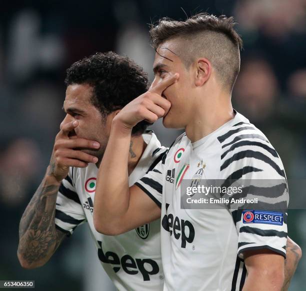 Paulo Dybala of Juventus FC celebrates with his team-mate Daniel Alves da Silva after scoring the opening goal during the UEFA Champions League Round...