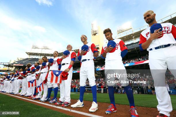 Team Puerto Rico stands for the national anthems prior to Game 1 of Pool F of the 2017 World Baseball Classic against Team Dominican Republic on...