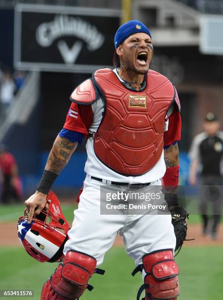 Yadier Molina of Puerto Rico reacts after tagging Jean Segura of the Dominican Republic out at the plate during the first inning of World Baseball...