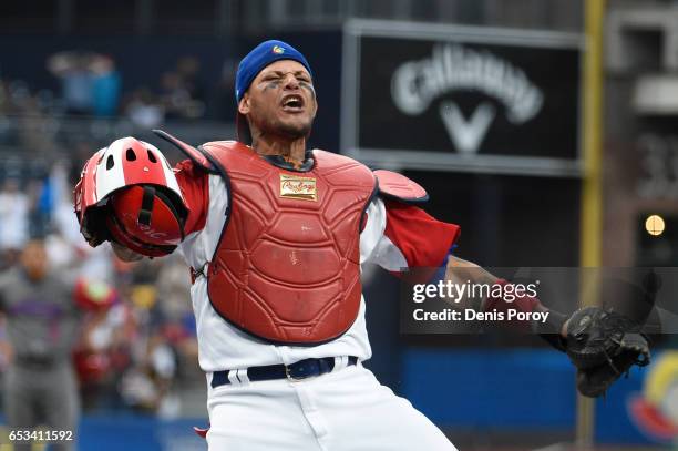 Yadier Molina of Puerto Rico reacts after tagging Jean Segura of the Dominican Republic out at the plate during the first inning of World Baseball...