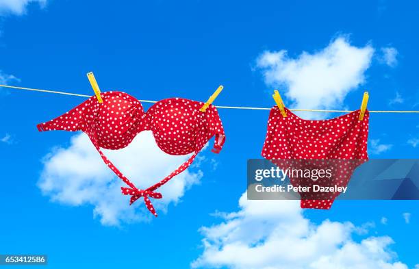 red spotty bikini hanging on clothes line - maillot de bain photos et images de collection
