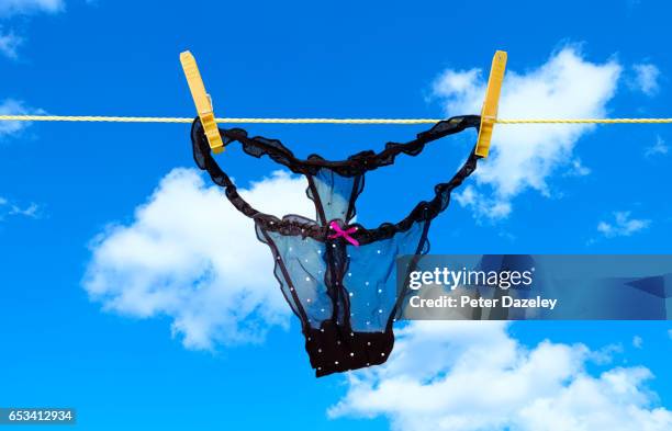 pulling knickers thong - string stockfoto's en -beelden