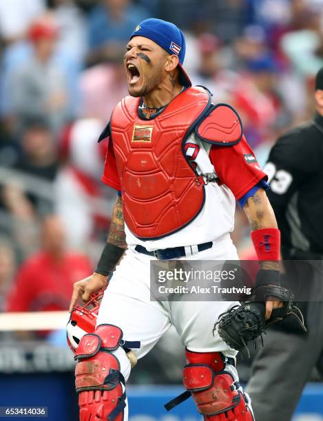 Yadier Molina of Team Puerto Rico reacts after tagging out Jean Segura of Team Dominican Republic for the third out of the top of the first inning of...