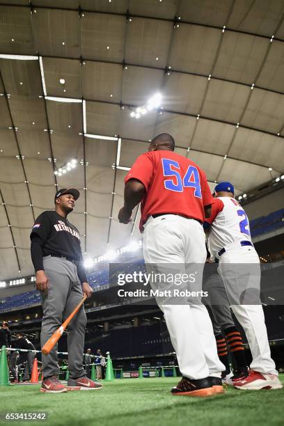 Outfielder Kalian Sams of the Netherlands talks with Outfielder Alfredo Despaigne and Designated hitter Frederich Cepeda of Cuba prior to the World...