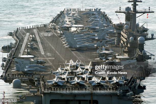 The U.S. Navy's nuclear-powered aircraft carrier Carl Vinson arrives at the port of Busan, South Korea on March 15 for ongoing joint military drills...