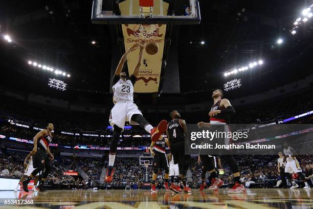 Anthony Davis of the New Orleans Pelicans dunks over Jusuf Nurkic of the Portland Trail Blazers and Maurice Harkless during the second half of a game...