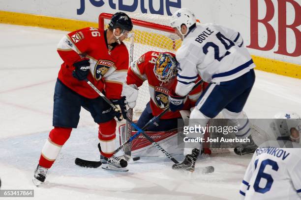 Goaltender James Reimer of the Florida Panthers stops a shot by Brian Boyle of the Toronto Maple Leafs as Jakub Kindl of the Panthers defends at the...