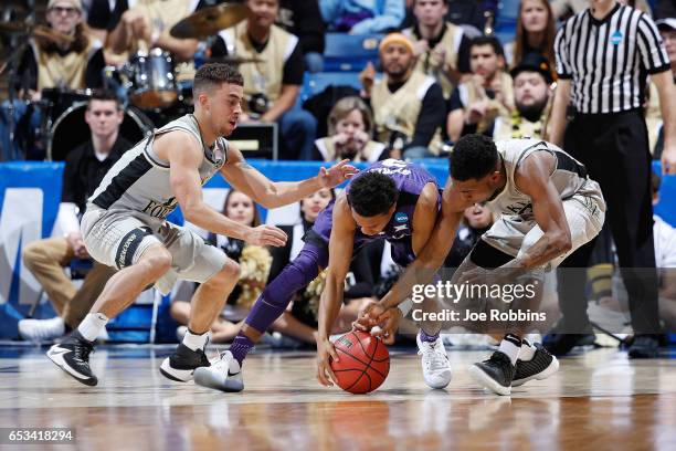 Kamau Stokes of the Kansas State Wildcats battles for the ball with Mitchell Wilbekin of the Wake Forest Demon Deacons and Bryant Crawford in the...