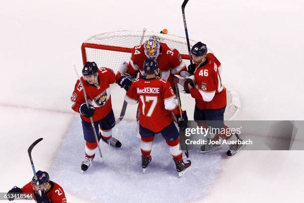 Goaltender James Reimer of the Florida Panthers celebrates the victory against the Toronto Maple Leafs with Mark Pysyk, Derek MacKenzie, and Jakub...