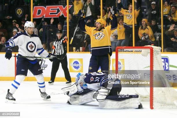 Nashville Predators center Mike Fisher and Winnipeg Jets goalie Connor Hellebuyck react to the game-winning goal by Nashville Predators right wing...