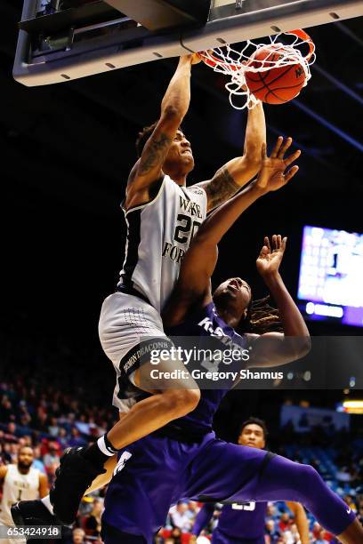 John Collins of the Wake Forest Demon Deacons dunks the ball against D.J. Johnson of the Kansas State Wildcats in the second half during the First...