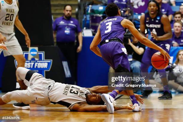 Bryant Crawford of the Wake Forest Demon Deacons fouls Kamau Stokes of the Kansas State Wildcats in the second half during the First Four game in the...