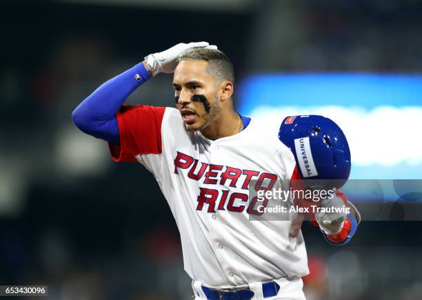 Carlos Correa of Team Puerto Rico reacts after getting on base in the bottom of the fifth inning of Game 1 of Pool F of the 2017 World Baseball...