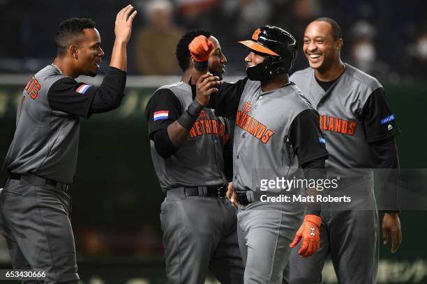 Infielder Yurendell de Caster of the Netherlands celebrates with his team mates after hitting a two run homerun to make it 7-0 in the top of the...