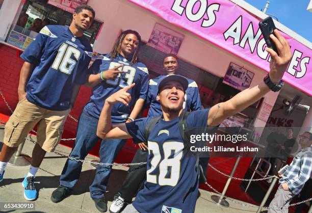 Wide receiver Tyler Williams, guard Donavon Clark and tackle Chris Hairston take a picture with fan at the unveiling of the "Chargers Chilli Cheese"...