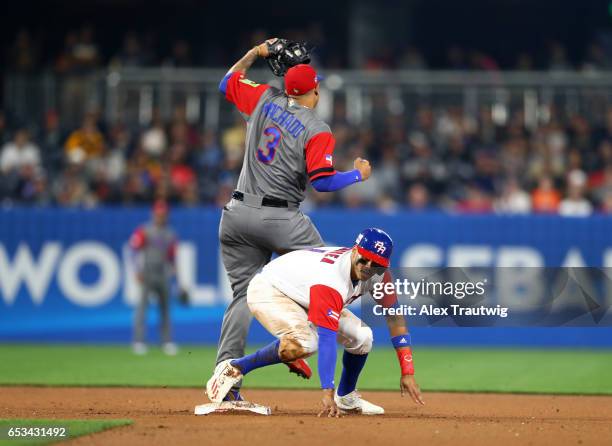 Carlos Correa of Team Puerto Rico is caught stealing as Manny Machado of Team Dominican Republic makes the tag in the bottom of the eighth inning of...