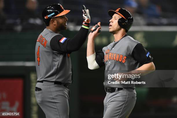 Infielder Andrelton Simmons of the Netherlands celebrates with Outfielder Wladimir Balentien after scoring a run by a RBI single of Outfielder...